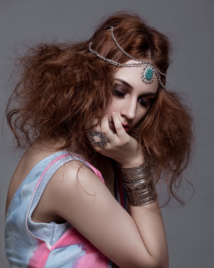 about-img-01 Side view of young trendy female model with makeup and closed eyes touching face